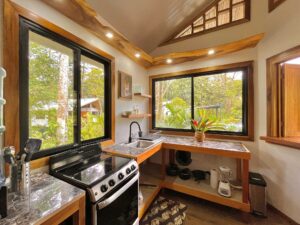 A kitchen inside one of the Dragonfly Beach Retreat guest casitas. Open and airy to the tropical garden